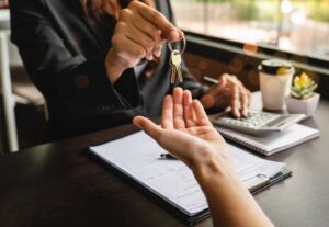 Estate agent handing house keys to a client