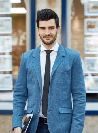 Business man standing outside of estate agents