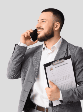 Professional man on the phone holding property documents